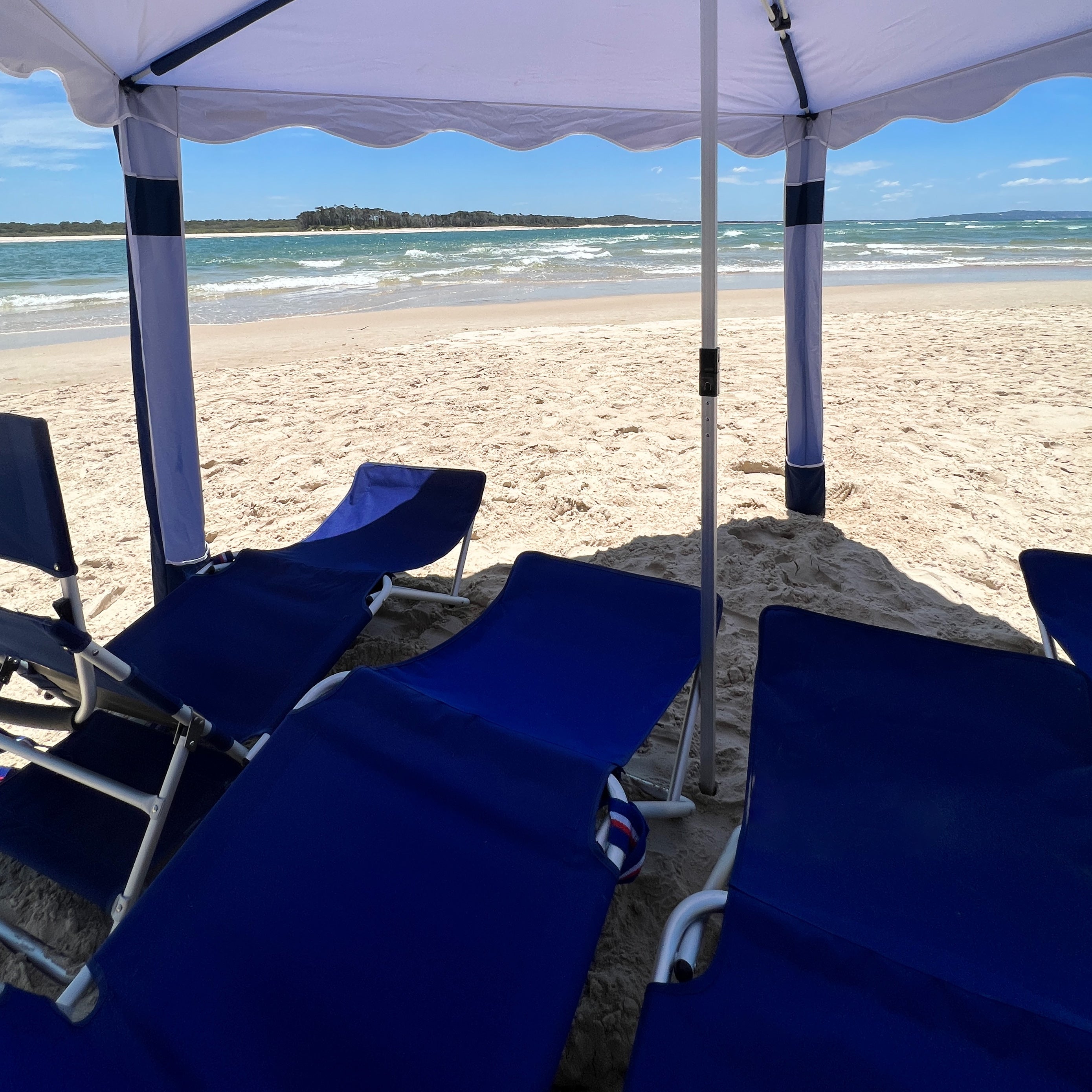 premium beach cabana coolcabana navy with white trim interior shot of coolcabana on the beach#color_burleigh