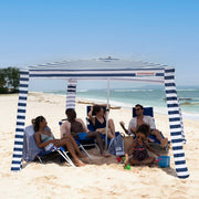 cool cabana with 5 people underneath#color_navy-stripes